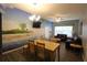 Beach-themed dining area with wood table and four chairs at 2305 Silver Palm Dr # 302, Kissimmee, FL 34747