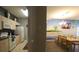 Open kitchen and dining area with island, granite countertops, and beach mural at 2305 Silver Palm Dr # 302, Kissimmee, FL 34747