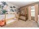 Bedroom with crib, toddler bed, and jungle-themed wall mural at 6728 Huntleigh Hammock Rd, Harmony, FL 34773