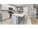 Modern kitchen with white cabinets, stainless steel appliances, and an island at 6728 Huntleigh Hammock Rd, Harmony, FL 34773