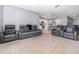 Spacious living room with reclining sofas and view of kitchen at 6728 Huntleigh Hammock Rd, Harmony, FL 34773