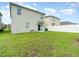 Spacious backyard with grassy area and home exterior view at 6728 Huntleigh Hammock Rd, Harmony, FL 34773