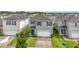 Two-story house with gray siding, white garage door, and landscaping at 6728 Huntleigh Hammock Rd, Harmony, FL 34773