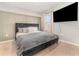 Bedroom with king-size bed and accent wall at 6728 Huntleigh Hammock Rd, Harmony, FL 34773