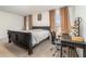 Main bedroom with a king-size bed and a workspace at 6728 Huntleigh Hammock Rd, Harmony, FL 34773