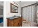 Well-lit bathroom with wood vanity and shower/tub combo at 1105 Monroe Ave., St Cloud, FL 34769