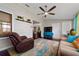 Relaxing sunroom with large windows, comfortable seating, and a TV at 1105 Monroe Ave., St Cloud, FL 34769
