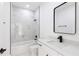 Clean bathroom with marble tile shower, white fixtures and vanity at 1306 Congo Dr, Poinciana, FL 34759
