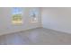 Bright bedroom with wood-look floors and two large windows at 1306 Congo Dr, Poinciana, FL 34759