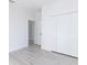 Simple bedroom with double door closet and wood-look flooring at 1306 Congo Dr, Poinciana, FL 34759