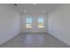 Bright bedroom with wood-look floors and two large windows at 1306 Congo Dr, Poinciana, FL 34759