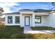 Contemporary single story home features a walkway to the front entrance at 1306 Congo Dr, Poinciana, FL 34759