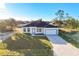 One-story home with a two-car garage and a light-colored facade at 1306 Congo Dr, Poinciana, FL 34759