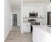 Modern kitchen with white cabinets and stainless steel appliances at 1306 Congo Dr, Poinciana, FL 34759