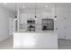 Modern kitchen with white cabinets, stainless steel appliances, and an island at 1306 Congo Dr, Poinciana, FL 34759