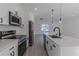 Clean kitchen showcasing stainless steel appliances and white cabinetry at 1306 Congo Dr, Poinciana, FL 34759