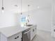 Modern kitchen island with white cabinets and stainless steel appliances at 1306 Congo Dr, Poinciana, FL 34759