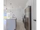 Modern kitchen with stainless steel appliances and white cabinets at 1306 Congo Dr, Poinciana, FL 34759
