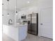Modern kitchen features white cabinets, stainless steel appliances, and an island at 1306 Congo Dr, Poinciana, FL 34759