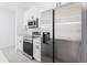 Modern kitchen with stainless steel appliances and white cabinets at 1306 Congo Dr, Poinciana, FL 34759
