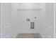 Bright laundry room with overhead shelving and vinyl flooring at 1306 Congo Dr, Poinciana, FL 34759