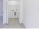 Laundry room with built-in shelving and vinyl flooring at 1306 Congo Dr, Poinciana, FL 34759