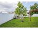 Large backyard with a pergola, fruit trees, and grassy area at 3044 Cameron Dr, Kissimmee, FL 34743