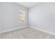 Simple bedroom with carpet flooring and a window with blinds at 15424 Enchanted Melody Way, Winter Garden, FL 34787
