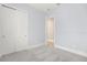 Empty bedroom with white doors and gray carpet at 15424 Enchanted Melody Way, Winter Garden, FL 34787