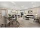 Open concept living room and kitchen with modern furniture at 15424 Enchanted Melody Way, Winter Garden, FL 34787