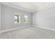 Bright bedroom with carpet and two windows at 15424 Enchanted Melody Way, Winter Garden, FL 34787