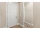 A simple hallway with white door and light beige walls at 15424 Enchanted Melody Way, Winter Garden, FL 34787