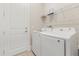 Laundry room with washer, dryer, and shelving at 15424 Enchanted Melody Way, Winter Garden, FL 34787