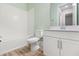 Clean bathroom with white cabinets, subway tile, and a bathtub at 15424 Enchanted Melody Way, Winter Garden, FL 34787