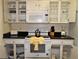 White cabinets, black countertops, and various kitchen appliances at 7671 Comrow St # 302, Kissimmee, FL 34747