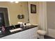 Bathroom with granite vanity, shower/tub combo and white cabinets at 7671 Comrow St # 302, Kissimmee, FL 34747