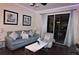 Living room with grey sofa, coffee table, and access to a balcony at 7671 Comrow St # 302, Kissimmee, FL 34747