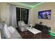 Living room with grey sofa, coffee table, and large TV at 7671 Comrow St # 302, Kissimmee, FL 34747