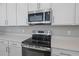 Stainless steel range and microwave hood in a modern kitchen setting at 2035 Stetson Ct, Eagle Lake, FL 33839