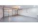 Spacious garage with light gray epoxy floor and overhead garage door at 2220 Crystal Grove Ln, Lakeland, FL 33801