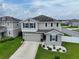 Two-story house with solar panels and landscaped yard at 592 Lake Smart Blvd, Winter Haven, FL 33881