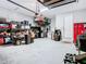 Spacious garage with storage, shelving, and extra refrigerator at 592 Lake Smart Blvd, Winter Haven, FL 33881