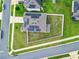 Aerial view of house with solar panels and fenced backyard at 592 Lake Smart Blvd, Winter Haven, FL 33881