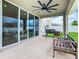 Covered patio with ceiling fan, grill, and bench at 592 Lake Smart Blvd, Winter Haven, FL 33881