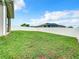 Large grassy backyard with a white vinyl fence at 592 Lake Smart Blvd, Winter Haven, FL 33881