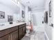 Bathroom with tub, double vanity, and Mickey Mouse decor at 592 Lake Smart Blvd, Winter Haven, FL 33881