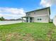 Spacious backyard with a covered patio and a large grassy area at 592 Lake Smart Blvd, Winter Haven, FL 33881