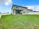 Large backyard with covered patio and grassy area at 592 Lake Smart Blvd, Winter Haven, FL 33881