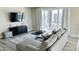 Living area with sectional sofa, access to balcony, and modern decor at 7740 Sandy Ridge Dr # 226, Kissimmee, FL 34747