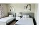 Guest bedroom with two twin-size beds and stylish wall art at 7740 Sandy Ridge Dr # 226, Kissimmee, FL 34747